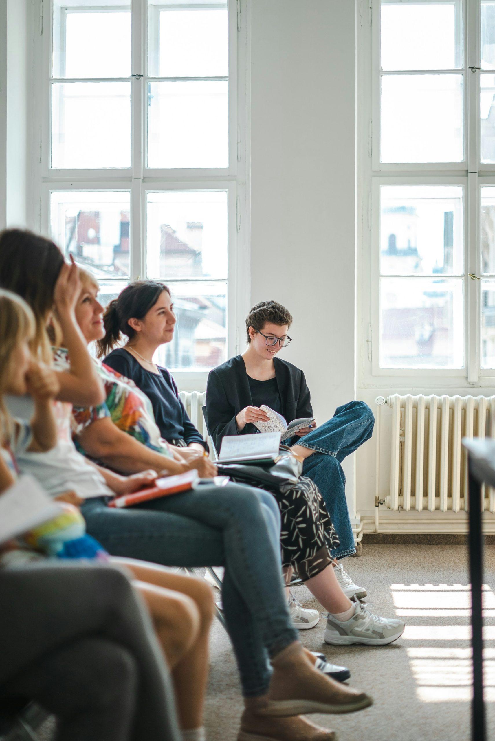 Group of professionals listening together — community of practice