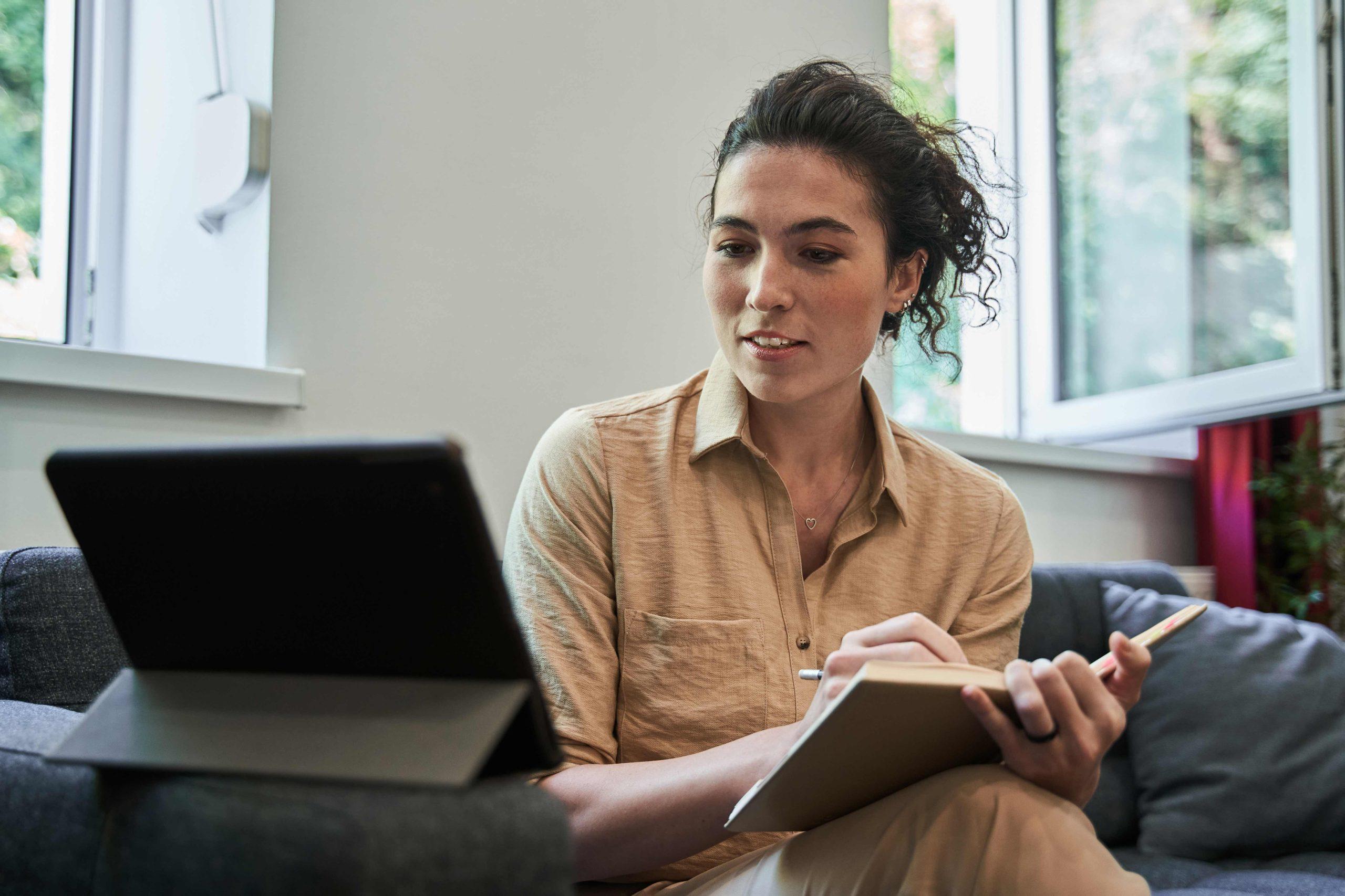 A psychologist studying with a tablet — typical of the CPD experience at Succoris Academy